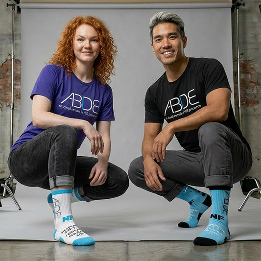 Models wearing Never Too Lost ABIDE White & Blue Sock Variants while wearing blue and black bamboo ABIDE tees