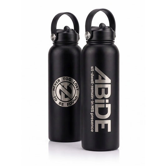Two black Water Bottles with optional drinking spout sports lid with handle, the one in front showing a laser engraved ABiDE sit - dwell - remain in HIS presence logo and the rear showing the back of the bottle with the signature Never Too Lost 'NTL' Logo with Never Too Lost To Be Found encircled around it.