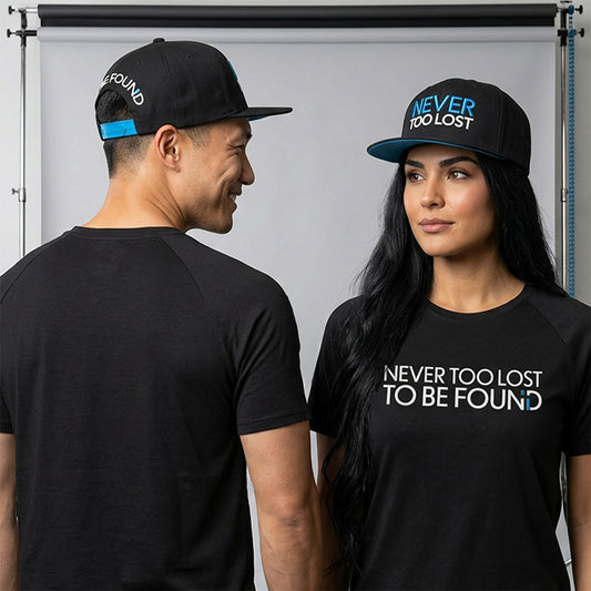 Man and woman wearing Never Too Lost To Be Found BLack Bamboo Tee with and Black Cotton Twill Hat