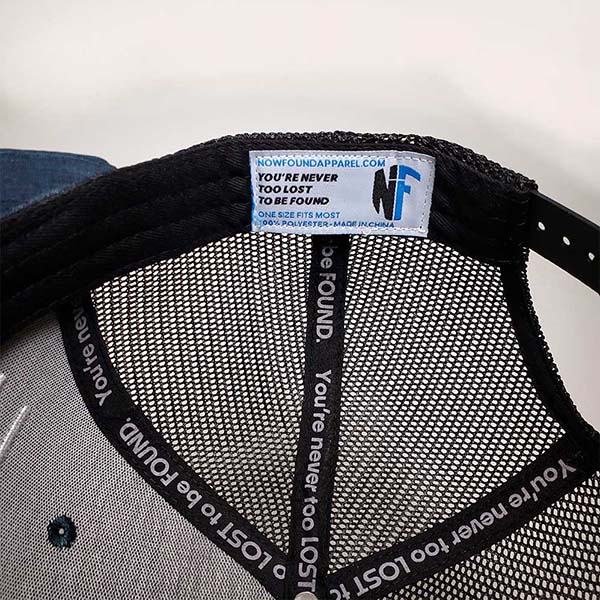 Ocean blue "Abide" trucker hat inside with never too lost to be found custom tape now found apparel