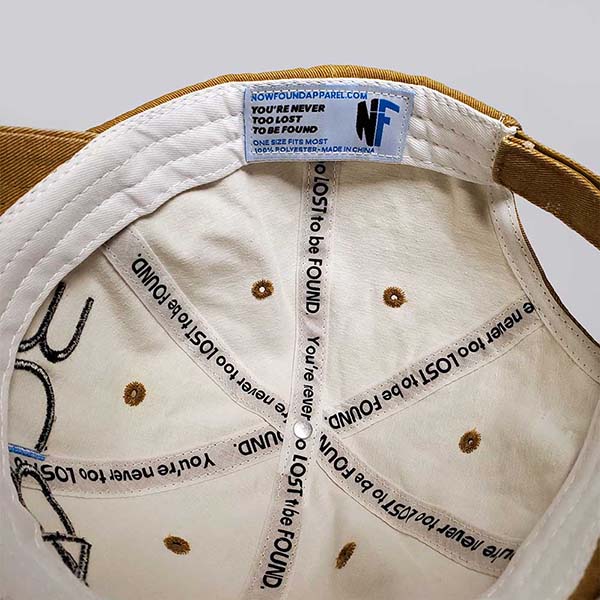 yellow dad hat with embroidered "Abide" logo, never too lost to be found interior tape from now found christian apparel