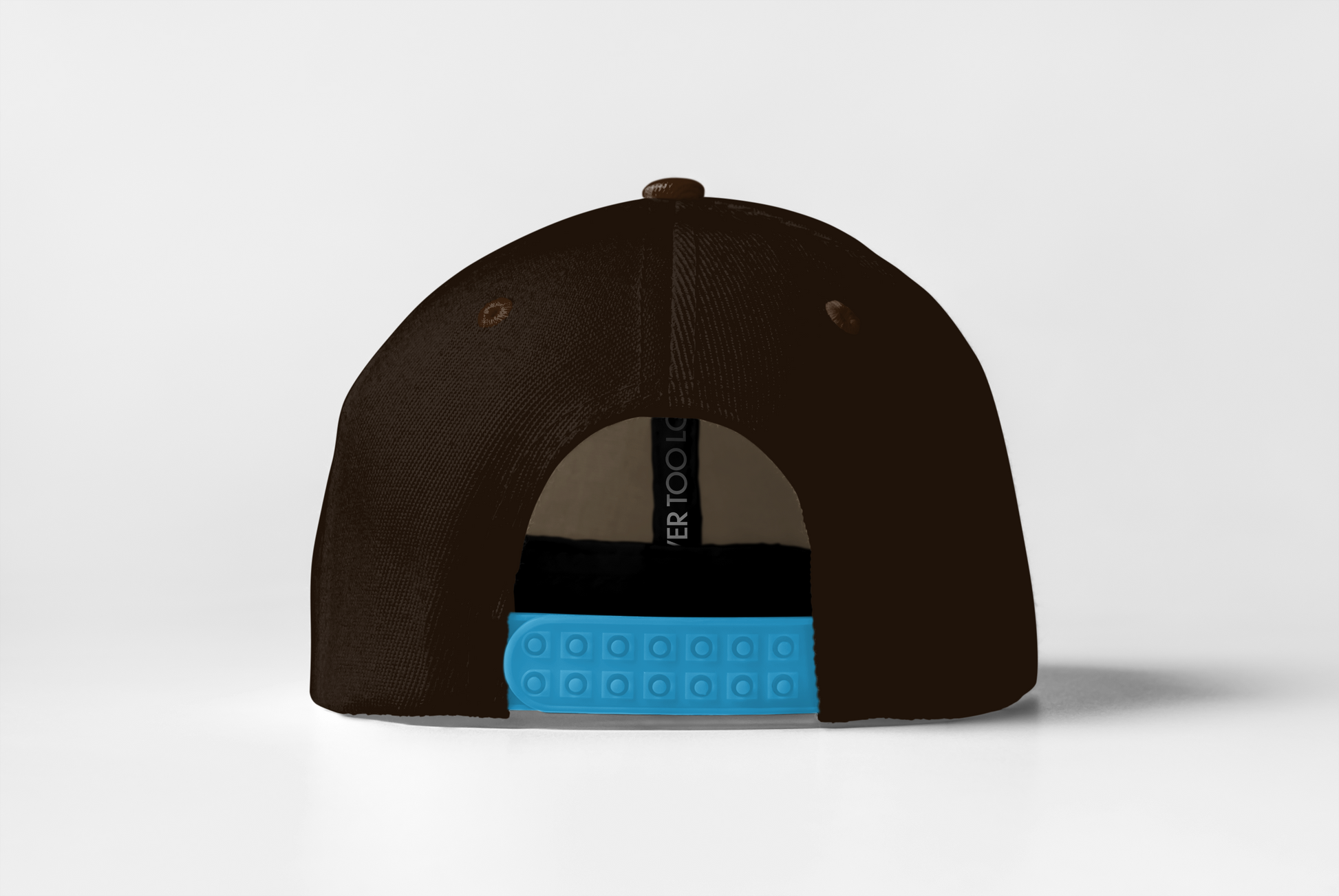 Dark brown cap with blue snap closure on a light gray background