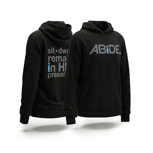 Two black pullover hoodies shown on a white studio background, with the front and back views overlapping. The front hoodie has a large gray ABiDE logo with a blue accent on the chest, and the back hoodie has gray and blue sit - dwell - remain in HIS presence text on the back.