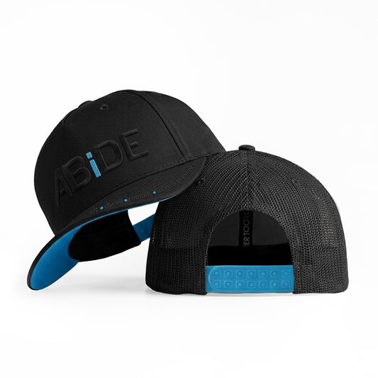 ABiDE sit - dwell - remain in HIS presence Black Trucker Hat with Blue "i" symboliing that we must decrease so He can increase
