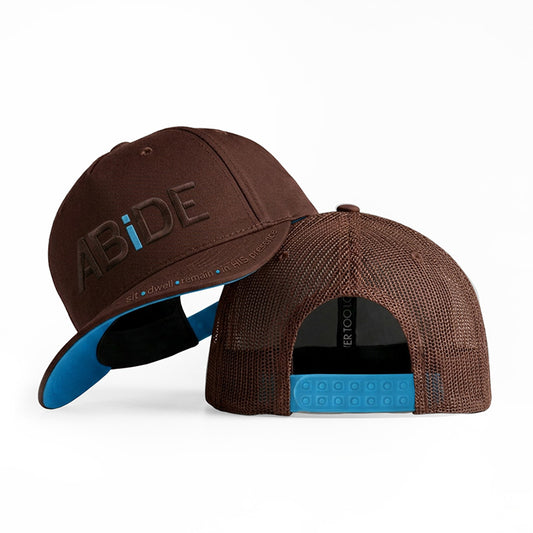 ABiDE sit - dwell - remain in HIS presence Brown Trucker Hat with Blue "i"