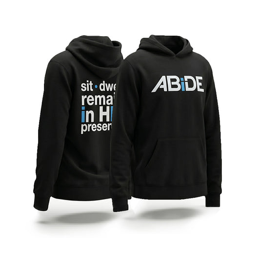 Black hoodie with ABiDE on the front and 'sit dwell remain in HIS presence' on the back, displayed from two angles.