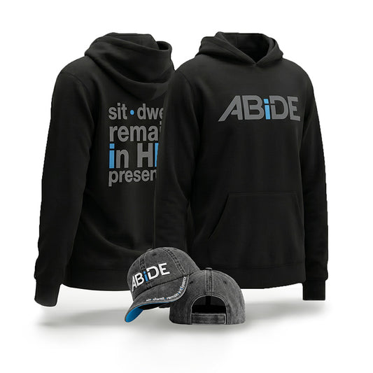 Black hoodie shown from front and back with white and blue text, plus a matching gray relaxed fit baseball cap with ABiDE - sit - dwell - remain in HIS presence branding, on a clean white background.