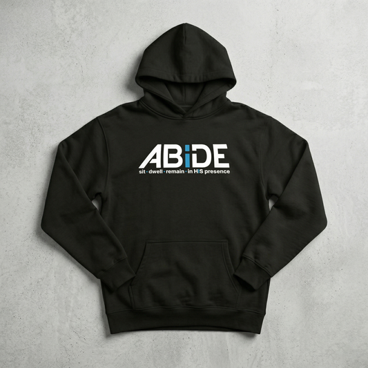 Black hoodie with 'ABIDE | sit - dwell - remain in HIS presence' text on a gray background