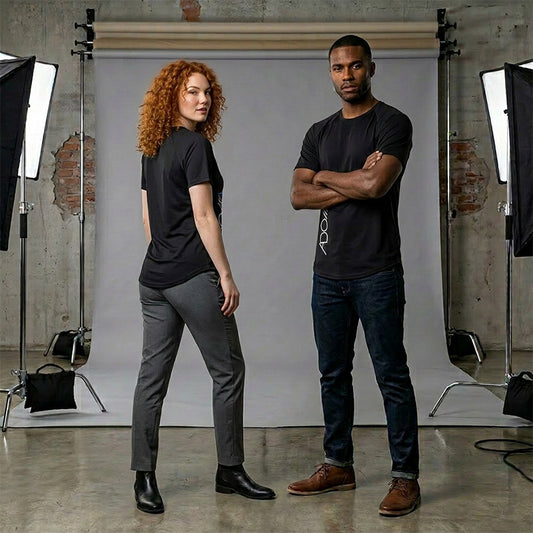 Two people standing in a studio wearing black ADONAI bamboo t-shirts