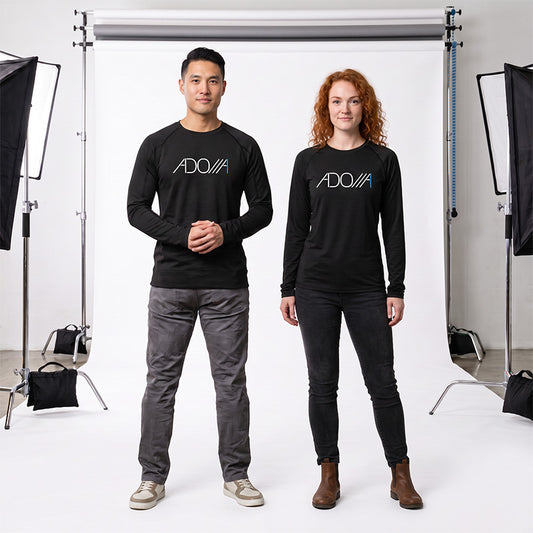 Two models standing in a studio setting wearing matching black long-sleeve crewneck shirts with a white and blue 'ADONAI' logo on the chest.