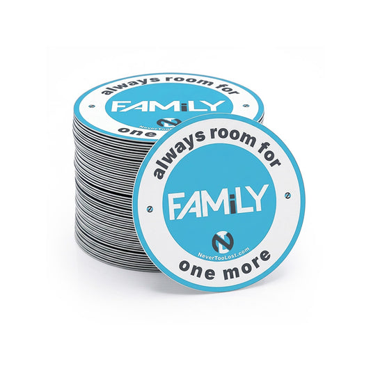 A stack of round vinyl stickers with one stacked in front, printed with the text 'FAMiLY - always room for one more' in grey on a white and bright blue background, shown on a clean white studio background.