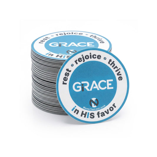 A stack of round vinyl stickers with a blue and white design featuring the word 'GRACE' and the phrase 'rest * rejoice * thrive in HIS favor'.