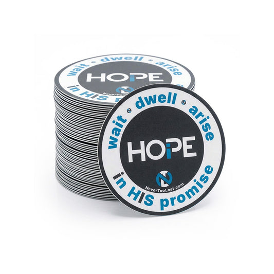 A stack of circular printed stickers with a dark grey, white, and blue design featuring the word 'HOPE' and the phrase 'wait dwell arise in HIS promise'. One sticker is placed in front of the stack on a clean white background.