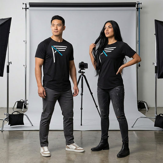 Two people wearing black I AM bamboo t-shirts in a photo studio setting.