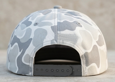 Light Gray Camouflage Victory hat on a light gray stone with a neutral background