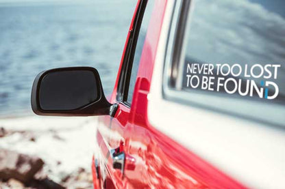 red jeep with Never Too Lost To Be Found sticker in rear window